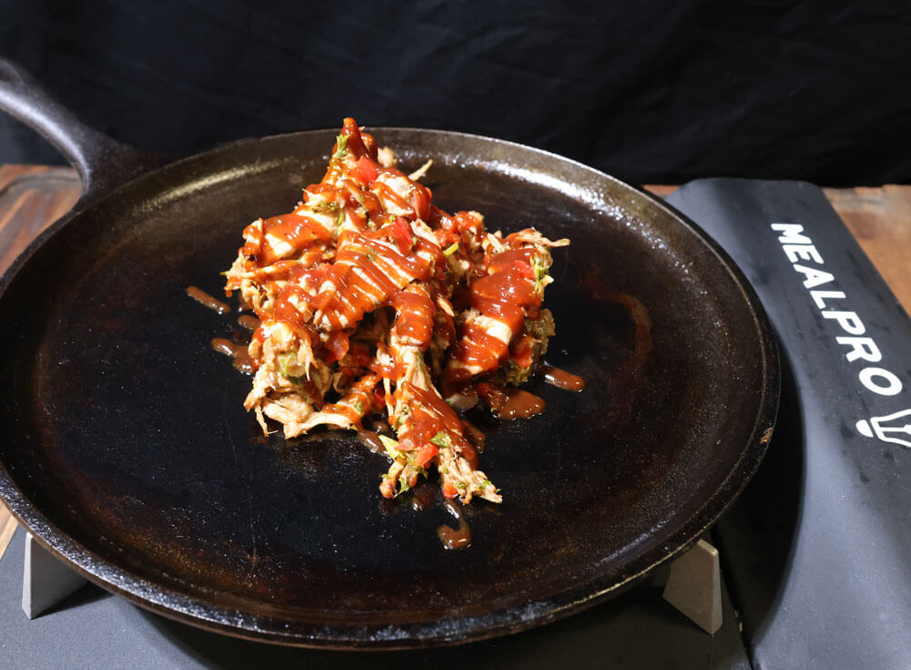 chef adds barbecue sauce to the pan