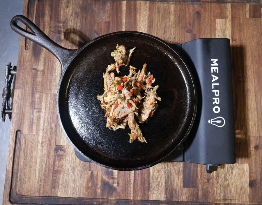 pulled pork added to hot pan